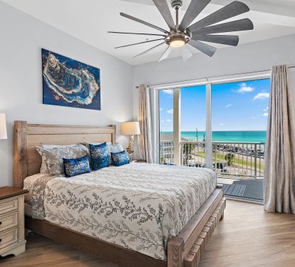 Master bedroom with king bed and balcony access