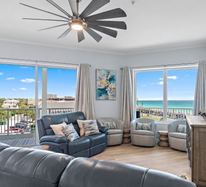 Living room with sectional, smart TV, and balcony access