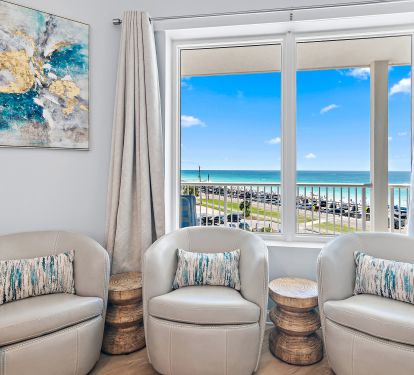 Living room with sectional, smart TV, and balcony access