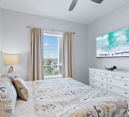 Guest king bedroom with dresser and TV
