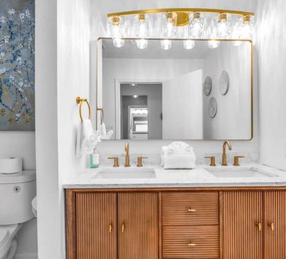 Enjoy the new master bath: Van Gogh florals, gold lights, modern vanity, and a waterfall shower.