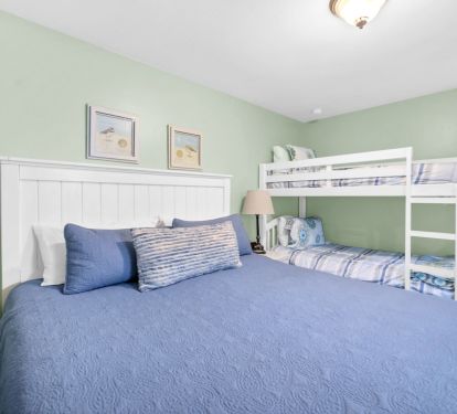 Guest room with comfortable king bed and twin bunk, smart tv