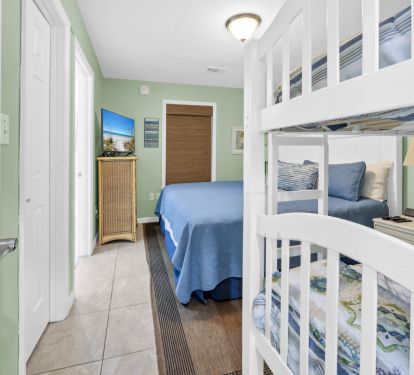 Guest room with comfortable king bed and twin bunk, smart tv
