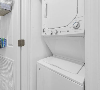 Stacked washer and dryer located in the hall laundry closet