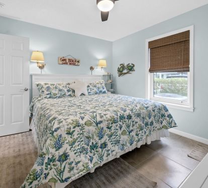 Master bedroom with comfortable king bed, ceiling fan and smart tv