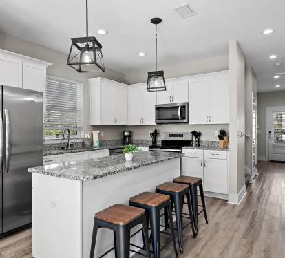 The kitchen is equipped with a large two-door refrigerator with ice maker, stove, oven, coffeemaker and dishwasher.