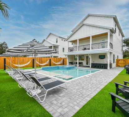 Satisfying Astroturf with luxury lounges, matching umbrellas, poolside hammocks, and putting green.