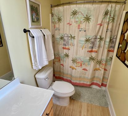 Primary Bathroom with curved shower curtain.