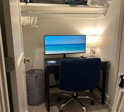 Dedicated Workspace - Tucked off the first-floor king suite, this private workspace features a small window, door, desk, comfortable chair, large monitor, docking station, keyboard, and a mouse—ideal for remote work while enjoying your beach getaway.