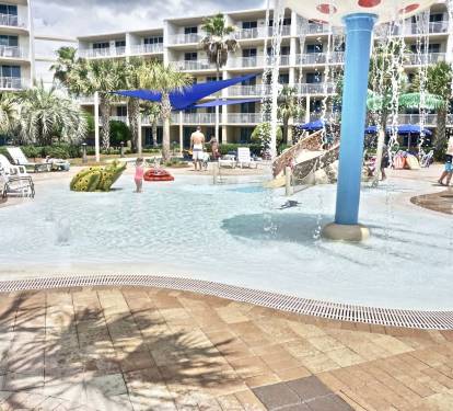Gated splash park keeps the littles from venturing too far from mom and dad!