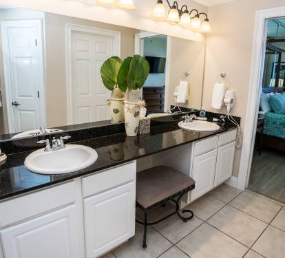 Another photo of the Double Sinks & Vanity. A pocket door closes off the bath area from the bedroom.