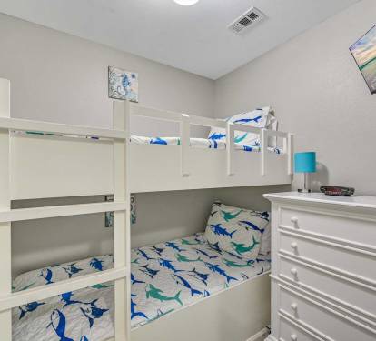 Kid-Approved Bunk Room - With fun bedding, a
cozy layout, and a space to stash all their beach
finds, this room is made for little travelers