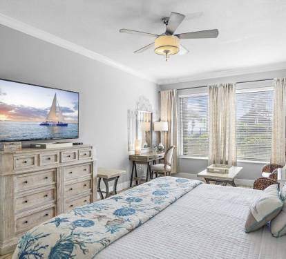 Wake Up in Paradise - The primary bedroom offers cozy bedding and a relaxing escape.