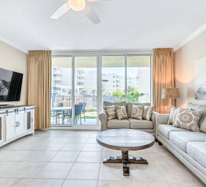 Blackout curtains with views of the upper heated pool, and garden landscaping. 