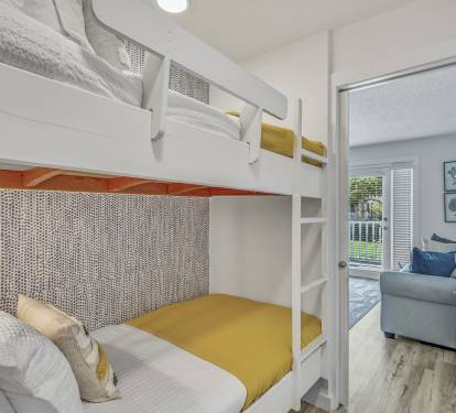 Hallway bunk beds off of the living room. Comfortable bedding, in-wall lighting, easy to use ladder right up to the top bunk. Pocket door for ample privacy and light control.