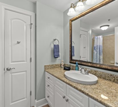Bunk room en suite bathroom w/ tub and shower and linen closet for extra storage