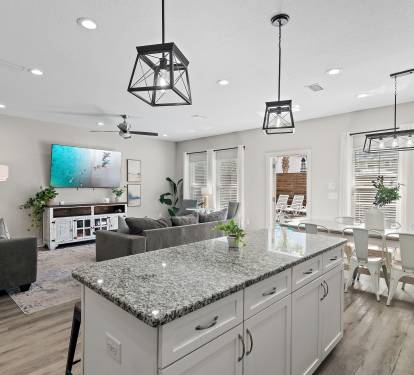 The open-concept living area includes a kitchen island, dining space, and kitchen.