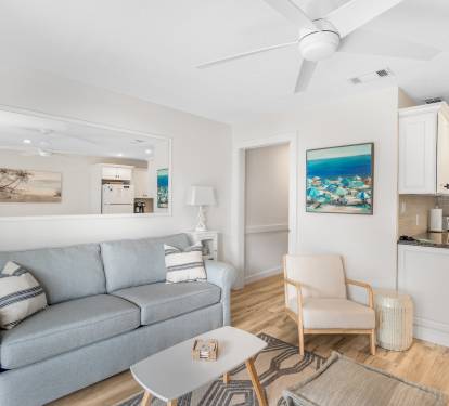 Cozy living room space with a comfy sleeper sofa, unlike others. Beachy accents and a ceiling fan to stay comfortable no matter the climate outdoors. 