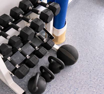 Dumbbells, kettlebells, and yoga mats for a well-rounded workout.