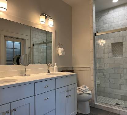 Upstairs king suite bathroom with double vanity, marble shower, and outdoor shower