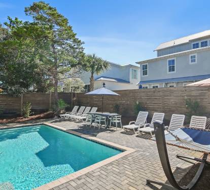The private pool area features lounges, poolside tables and chairs, a hammock, and a grill.