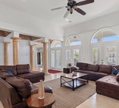Spacious living area with high ceilings and abundant natural light