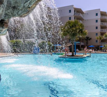 Relax under the waterfall feature in the lower pool on hot days. 
