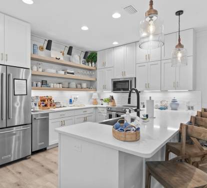 Fully stocked kitchen with KitchenAid refrigerator with filtered water and ice, a separate ice maker, stove, oven, microwave, and coffee/tea bar.