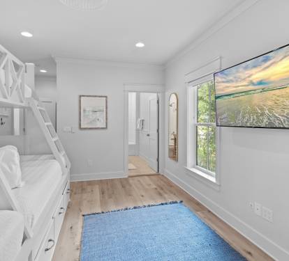 Spacious 2nd level twins over queens bunk room with full ensuite bathroom, tiled shower with tub, and a large vanity.