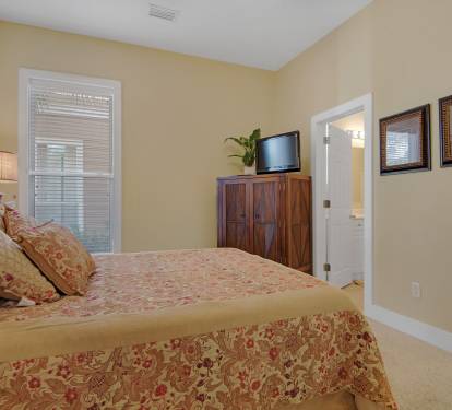 first floor queen bedroom has flat screen tv