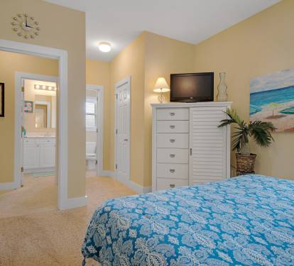 second floor queen bedroom has flat screen tv and access to bath