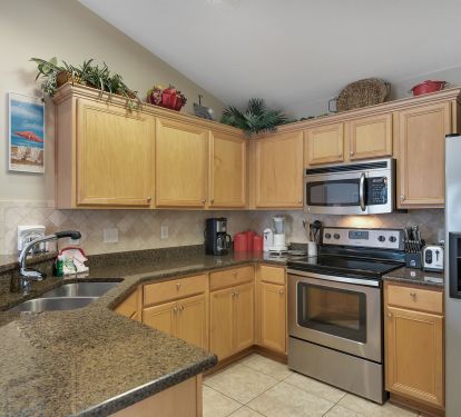 Well equipped kitchen with granite counter tops and tiled back splash!