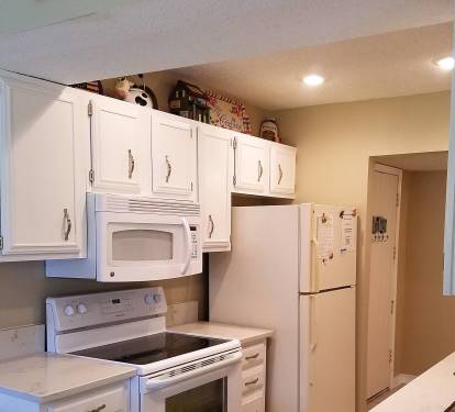 Galley kitchen features granite countertops