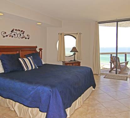 Large Master bedroom with king size bed. Access to balcony and beach view. 