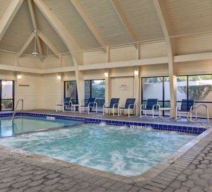 Indoor pool and hot tub adjacent to the workout room