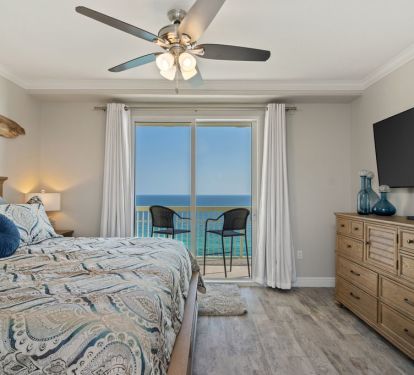 Master bedroom with King bed, large screen television, and walk-in closet..
