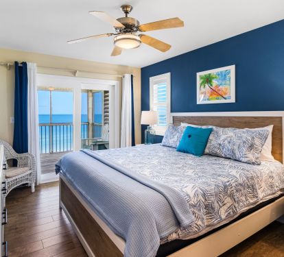 Gulf facing King bedroom. Access a large screened porch through the glass slider