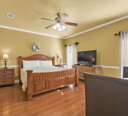 Master Bedroom with King size bed and smart tv.