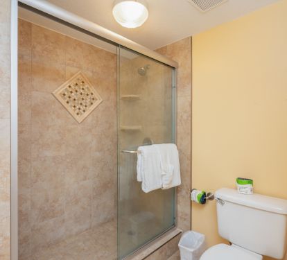 Enjoy the upgraded tile shower with glass accents and clear glass sliding door