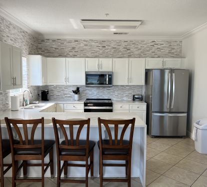 Newly renovated kitchen (showing old chairs)