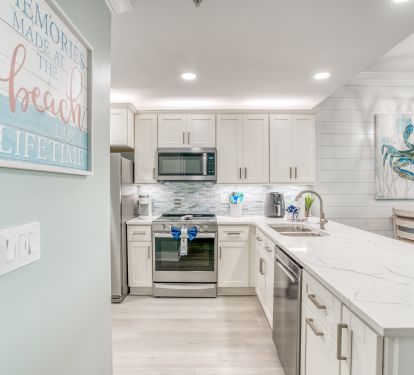 Freshly renovated kitchen featuring elegant quartz counters &amp; stainless 