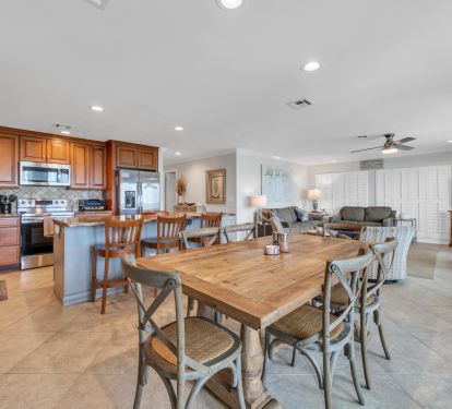 View ot dining table, kitchen and living area