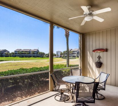 Patio overlooks 14th green of golf course, a water-protected par 4