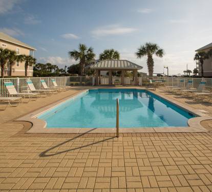 Our sparkling pool also has a covered patio, bathrooms and a shower.