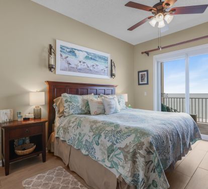 Master bedroom with king size bed and access to balcony