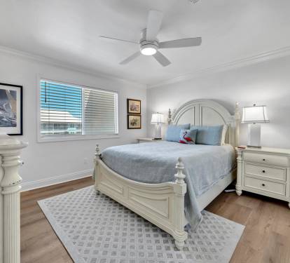 2nd guest bedroom with comfortable queen bed, flat screen tv and ceiling fan