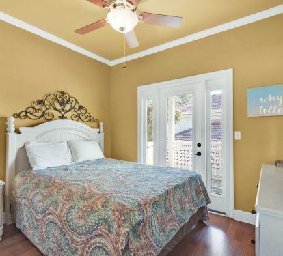 upstairs queen bedroom with access to covered balcony porch.