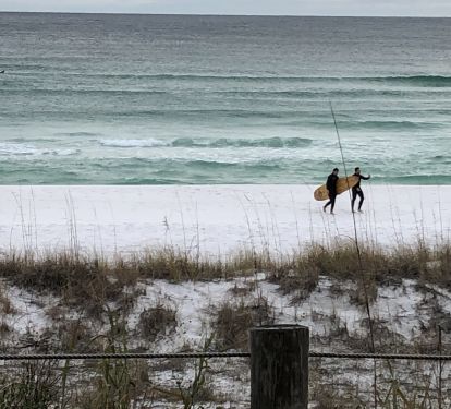 Surfer boys catching some waves outside condo