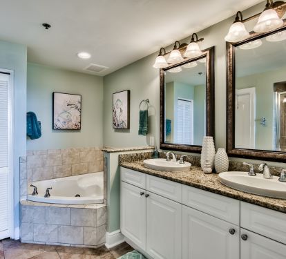 En Suite bathroom with jetted jacuzzi tub, WC, tiled shower, and two sinks