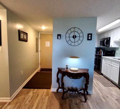 Kitchen on right, front door left of center, master bedroom dorway on left.